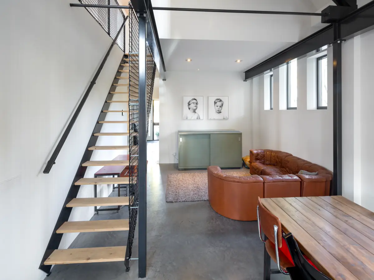 Couch-Ecke mit schmaler Treppe ins Obergeschoss