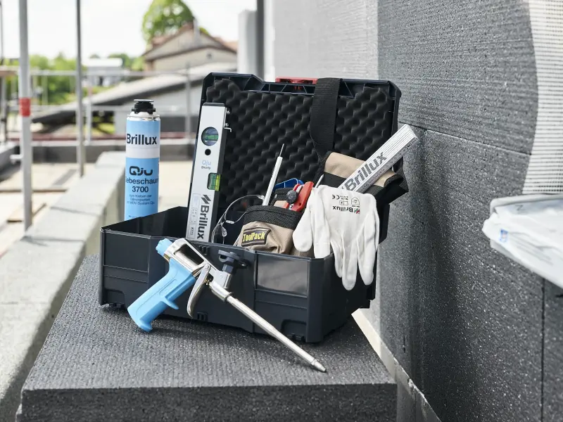 Geöffneter Handwerkerkoffer mit Produkten und Handschuhen