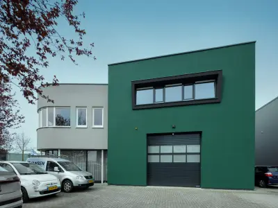 Grüne Fassade mit Garagentor