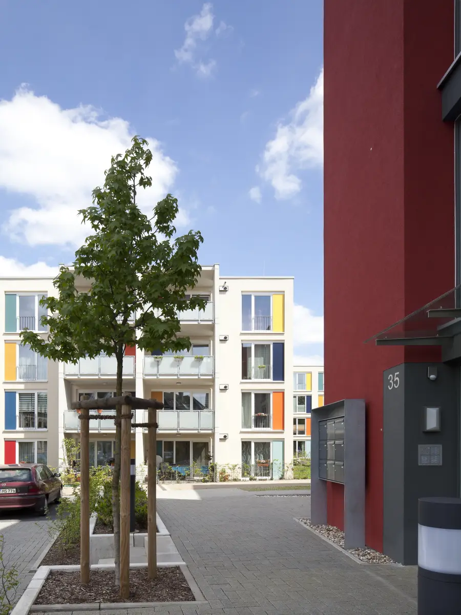Gebäude mit weißen Fassaden und bunten Fensterrahmen