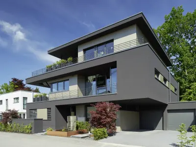 mehrstöckiges Einfamilienhaus mit schwarzer Fassade und 2 Terassen 