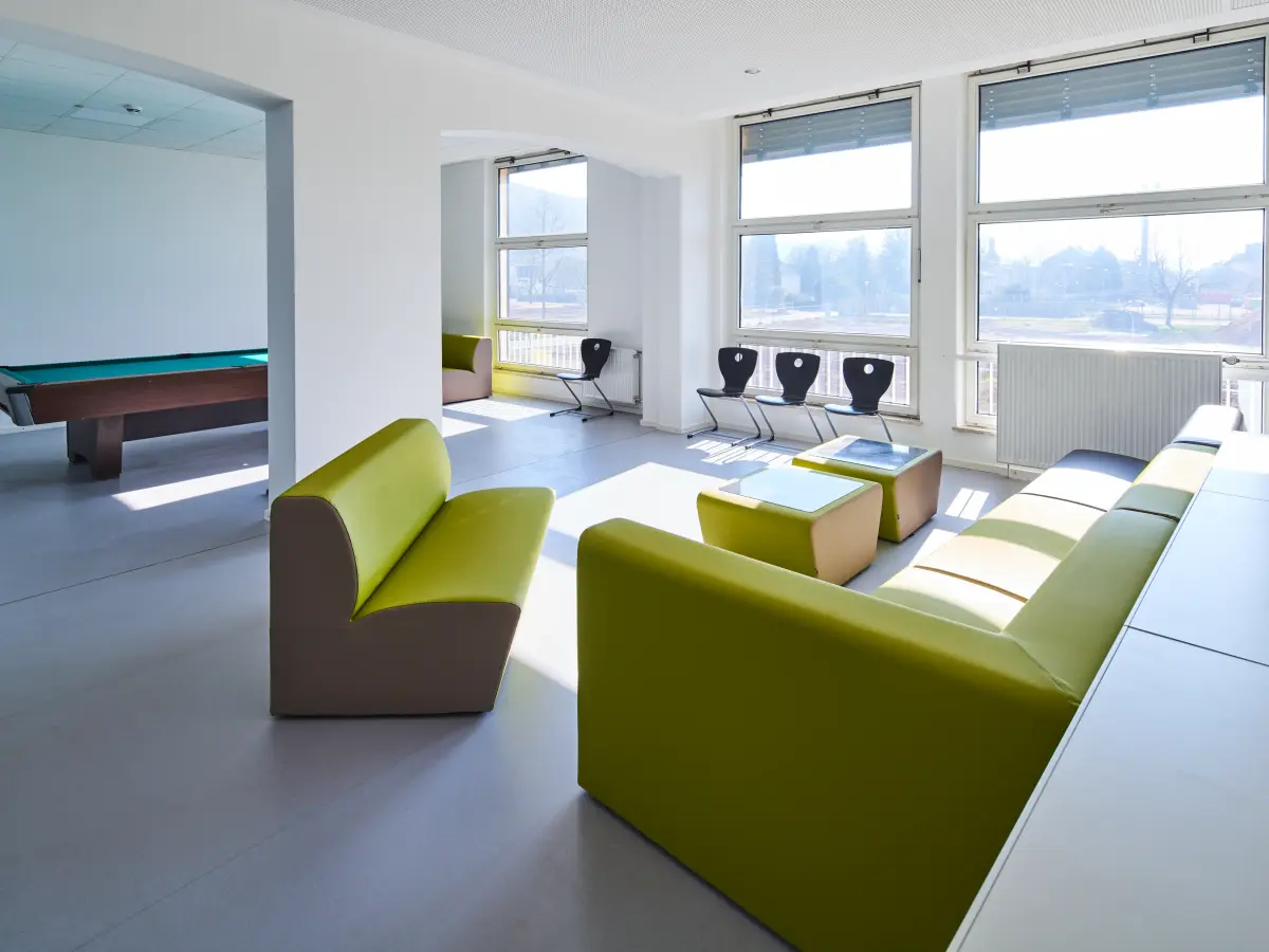 Aufenthaltsraum mit grünen Sofas