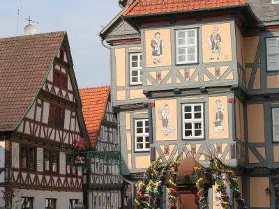 Fachwerkhaus mit Zeichnungen von damaligen Figuren mit unterschiedlichen Berufen