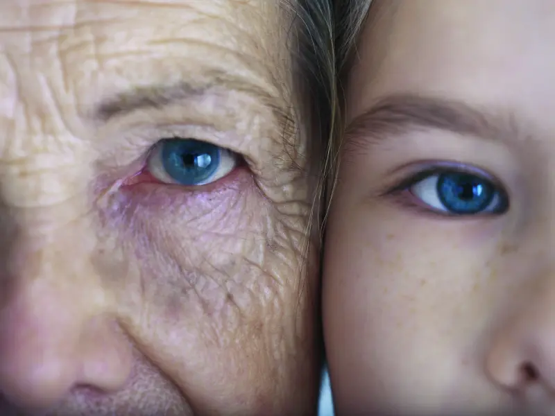 Zoom auf das Auge von zwei Gesichtern - eine alte Frau und ein junges Mädchen